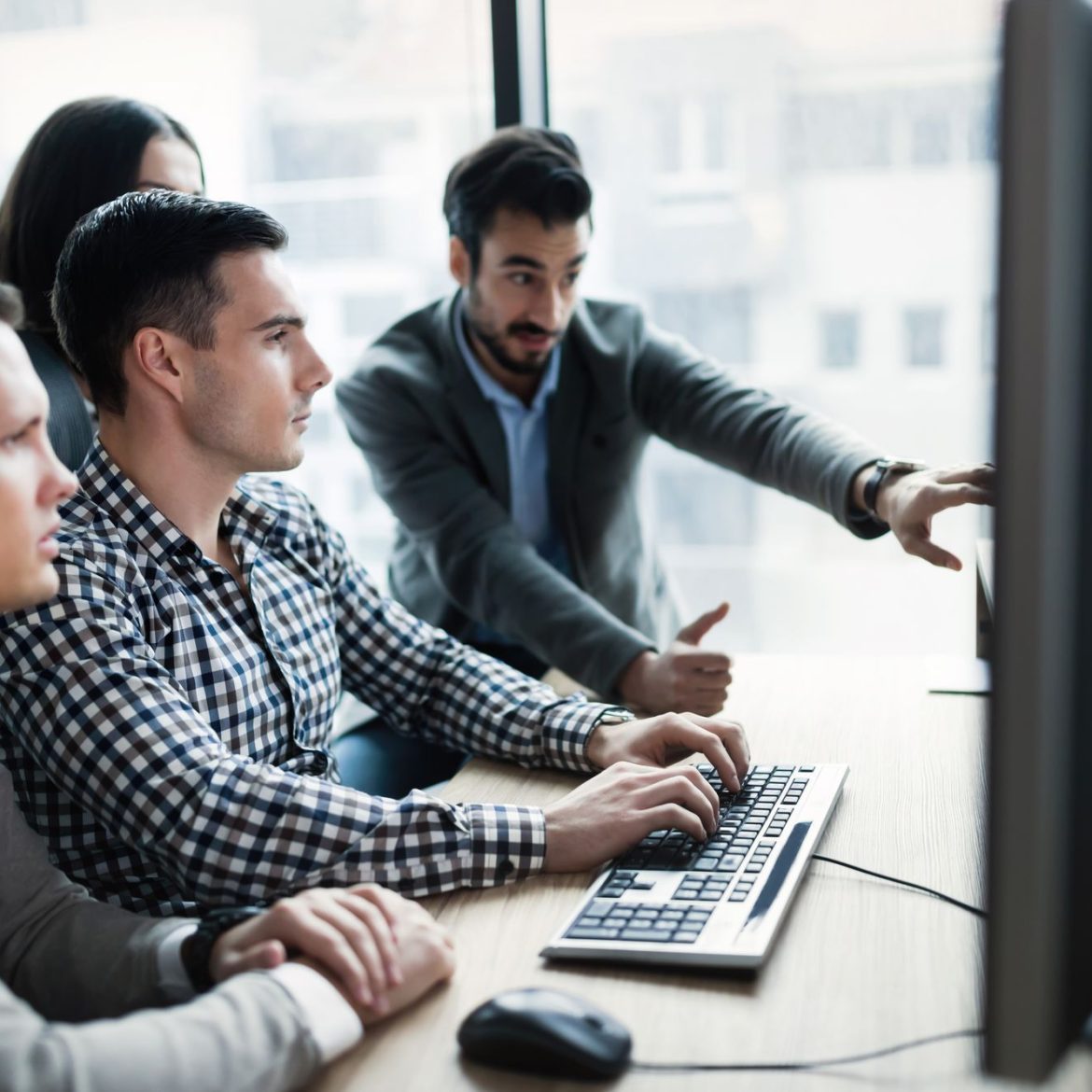 Young businesspeople working on computer in modern office