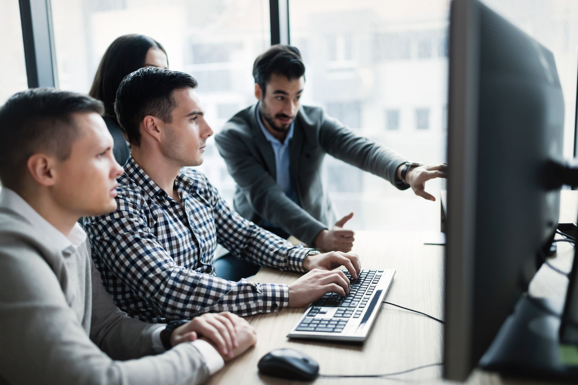 Young businesspeople working on computer in modern office